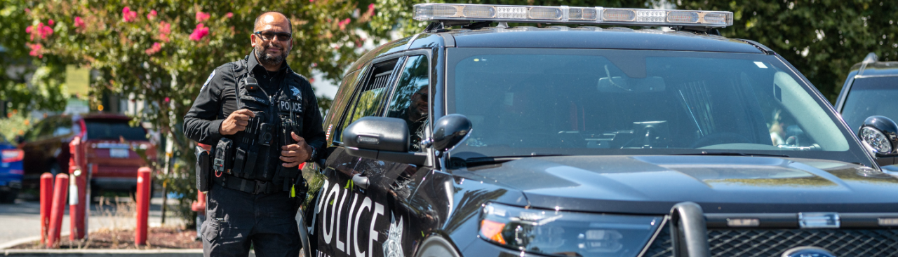 Officer in front of car